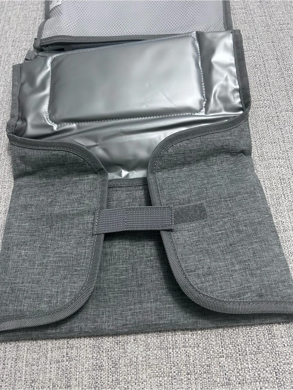 Grey Foldable Portable Changing Pad for Baby with Secure Buckle.